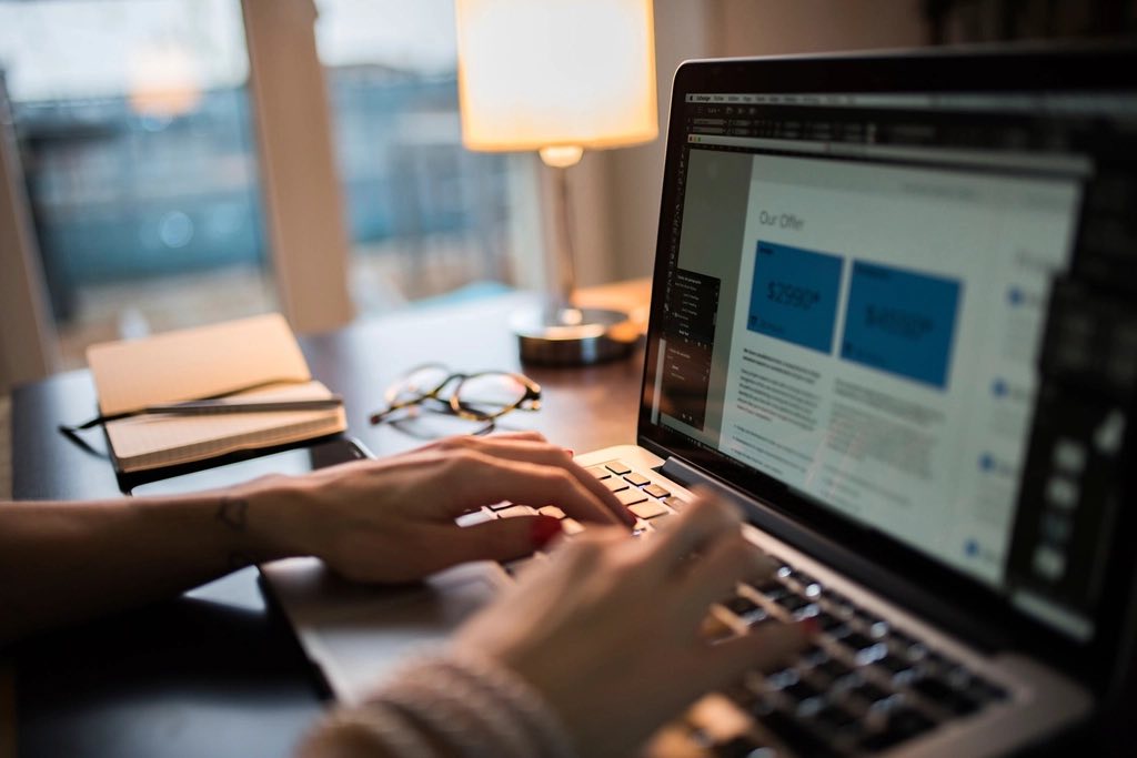Working at a laptop showing an account screen