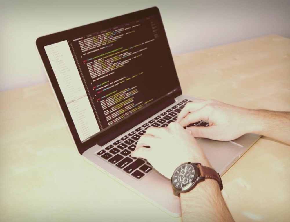 Writing code on a laptop