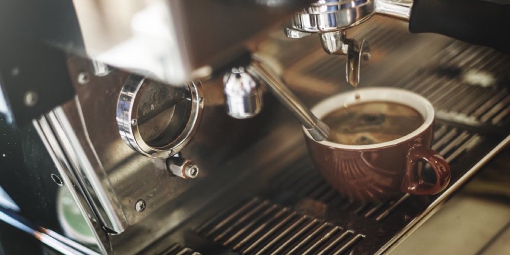 Espresso being poured at a cafe counter